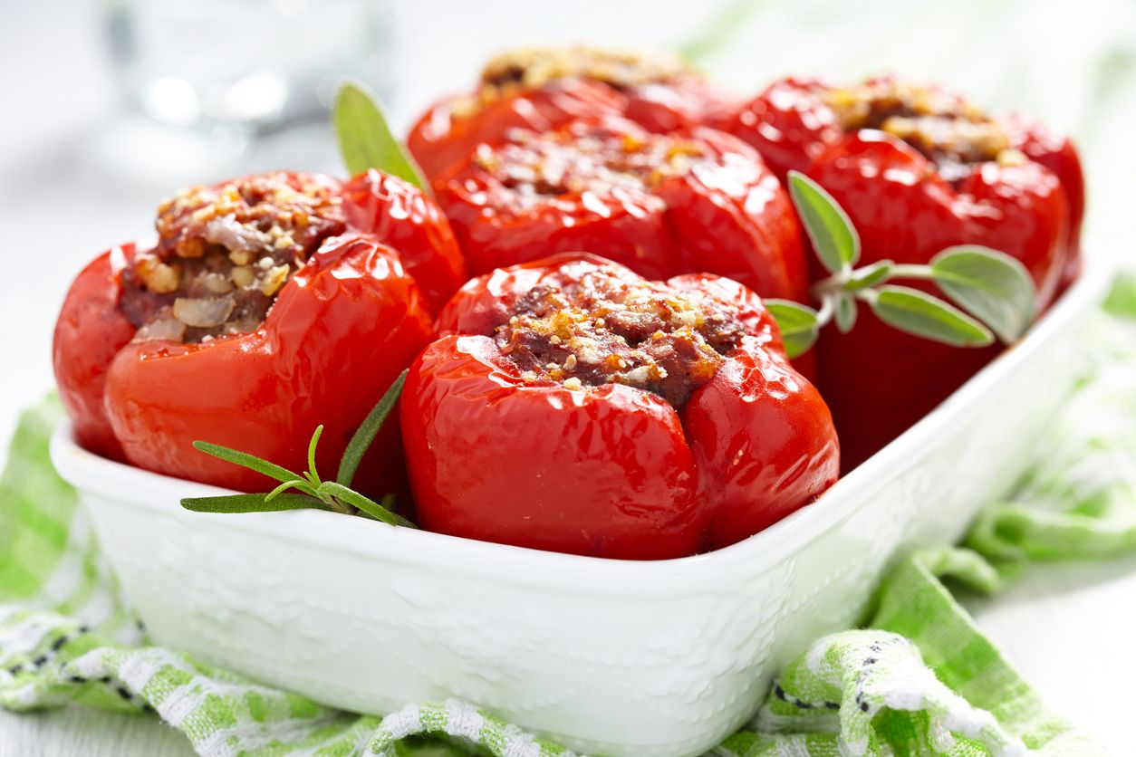 Traditional stuffed bell peppers with tomato sauce and infused rice